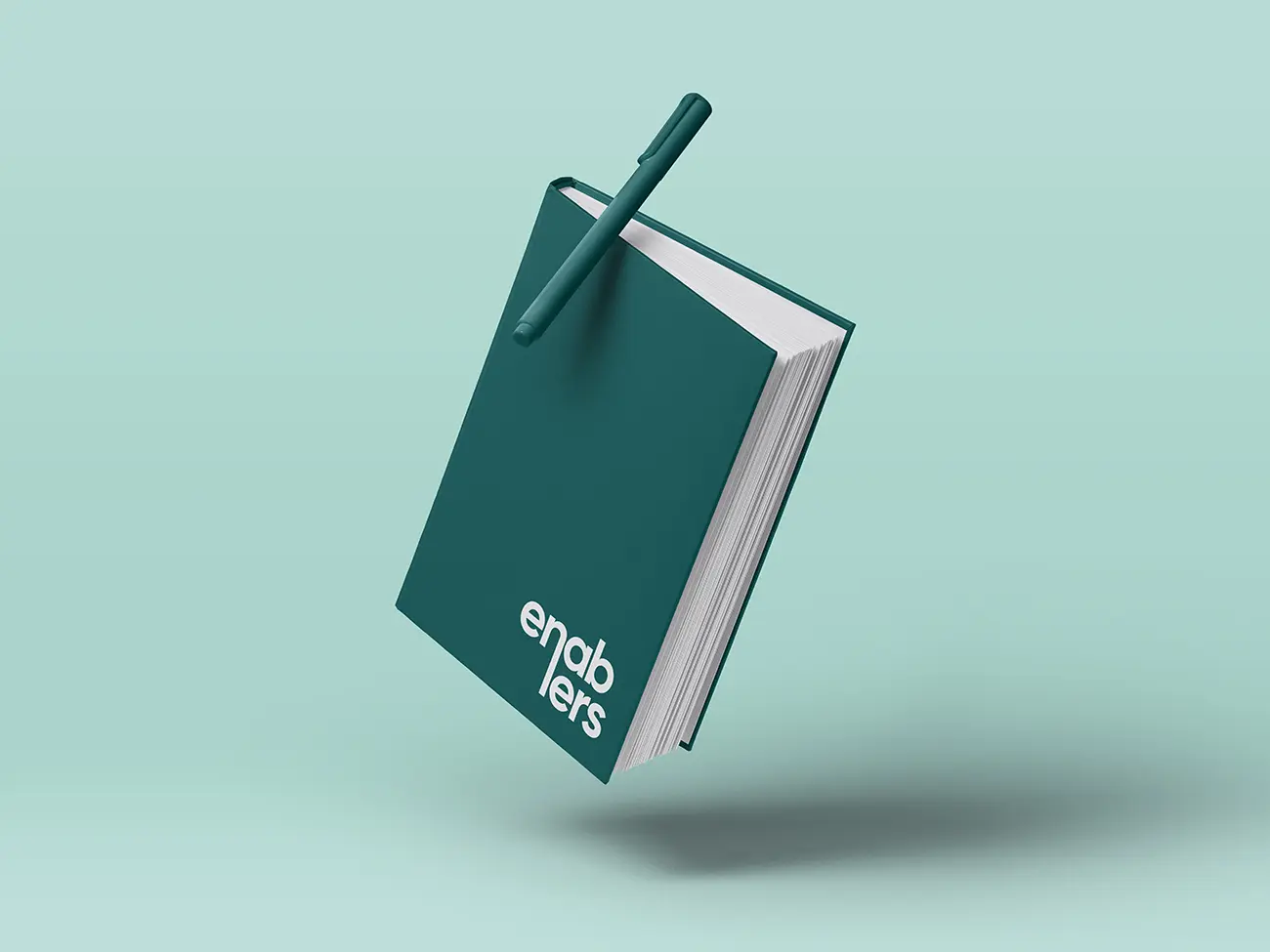 Grøn notesbog med hvidt enablers logo